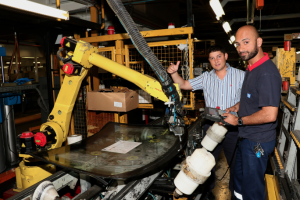 NMMU Mechatronics Engineering graduate, Nathan Kops, left, is now a full-time employee at GMSA. Inspecting one of the robotic systems in the Struandale assembly plant with him, is Automation Technician, Rais Salie.   