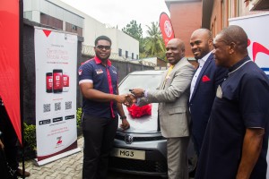CHISCO's Executive Director, Obinna Anyaegbu, receiving the key of the star prize, MG 3 car, from the General Manager, Marketing and Corporate Services, Coscharis Group, Mr. Abiona Babarinde