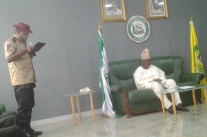 Corps Commander Oladele (standing) reads his speech during the visit as Gov. Ibikunle Amosun listens