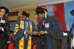 Maduka receives the award from ABUAD Vice Chancellor, Prof. Ajisafe