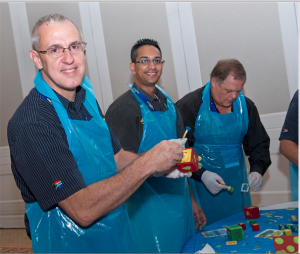 Goodyear South Africa Manufacturing Director, Celso Lahr (left) decorates building blocks as part of a team building activity with fellow team mates Sudesh Samlall (middle) and Deon Botha (right). 