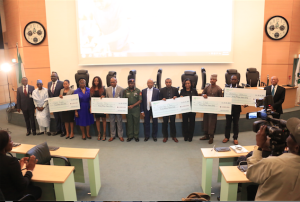 Other beneficiaries display their cheques at the disbursement ceremony