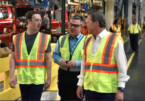 Facebook CEO Mark Zuckerberg (left) tours Ford's Dearborn Truck Plant with Ford Executive Chairman Bill Ford (right) and plant manager Brad Huff.