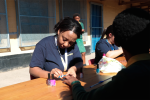Vernicula Romain, a Goodyear employee, adding some colour to a learner’s nails