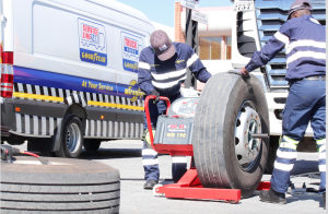 Service technicians demonstrate wheel balancing on the state-of-the-art-balancing-machine that comes with the Truckforce Mobile Van