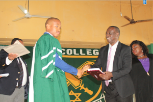 From right:  The Permanent Secretary, Edo State Civil Service Commission, Reverend S.O Uwuangue, presenting the Senator David Dafinone prize for Best student in Accounts  to Master  Eguavoen Constance, at the graduation/ prize giving ceremony  