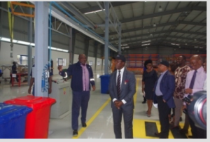The Plant Coordinator, Mr. Sola Afolayan, explains a point of interest to the Coscharis Group President, Dr. Cosmas Maduka, and others during the tour of the facility
