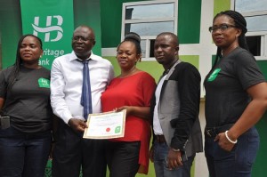 From left:  Zonal Head, South-West, Agent Banking, Heritage Bank, Oluwakemi Adewunmi; Managing Director, Dunmop Ventures/Agent, Mr Ayo Kale, his wife, Oluwakemi ; Managing Director, OC Ventures, Mr Hassan Azeez Olasukanmi, and Experience Centre Manager, Idumagbo, Nneoma Orji, at the inauguration of the new agent banking partner by Heritage Bank in Lagos …on Tuesday